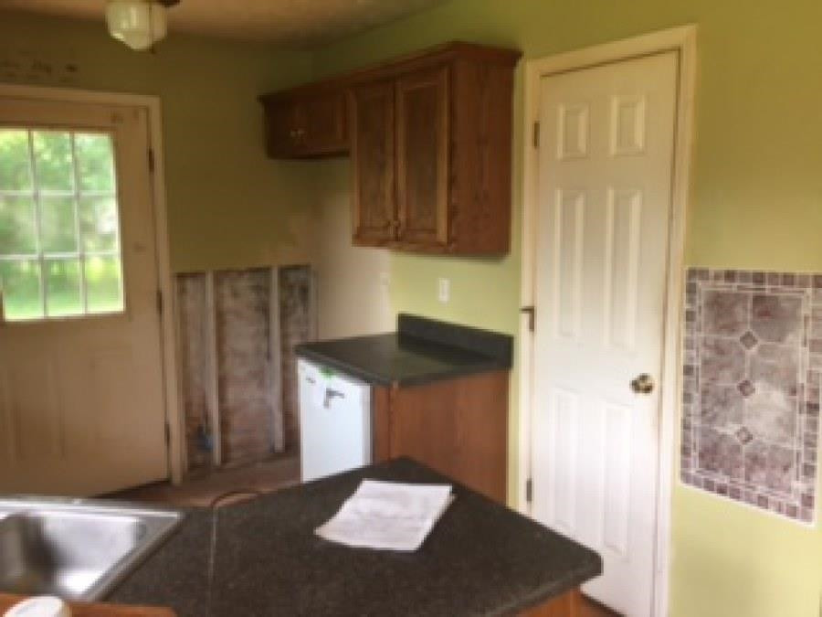 122 Booker Street Jackson, TN 38301 - Photo 11 of 18 a kitchen with a refrigerator and a stove