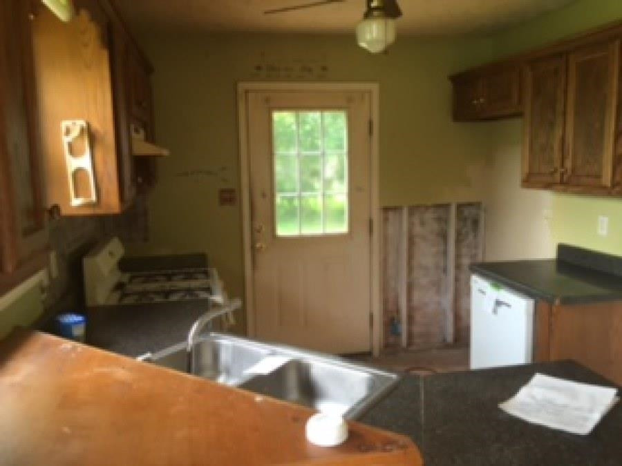122 Booker Street Jackson, TN 38301 - Photo 12 of 18 a kitchen with a sink a counter top space and cabinets