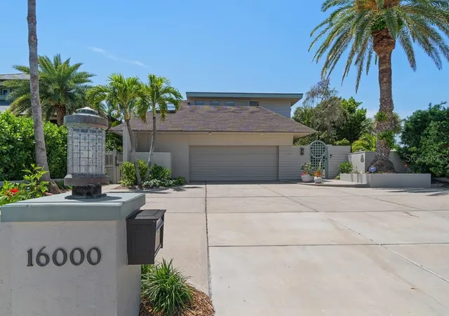 a front view of a house with a yard and a garage