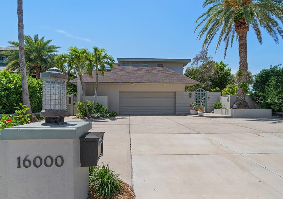 16000 Gulf Boulevard Redington Beach, FL 33708 - Photo 1 of 47 a front view of a house with a yard and a garage