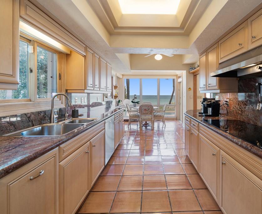16000 Gulf Boulevard Redington Beach, FL 33708 - Photo 19 of 47 a large kitchen with stainless steel appliances granite countertop a stove a sink and a microwave