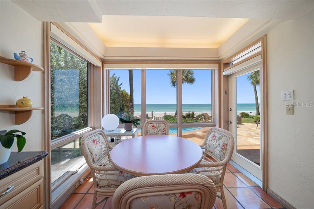 16000 Gulf Boulevard Redington Beach, FL 33708 - Photo 20 of 47 a view of a dining room with furniture large windows and wooden floor