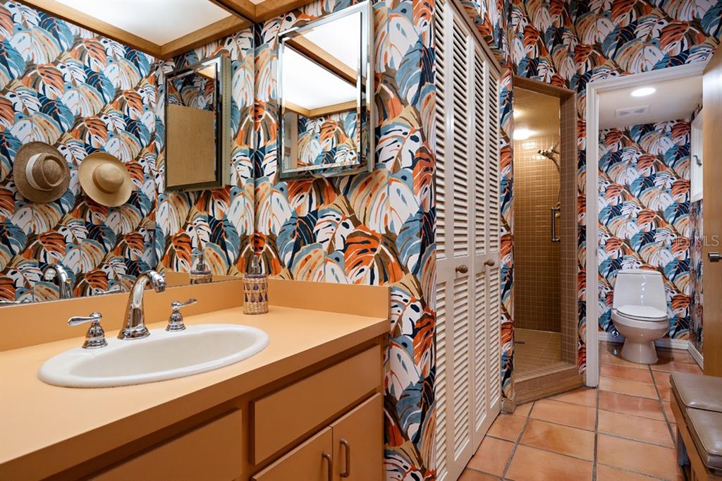 16000 Gulf Boulevard Redington Beach, FL 33708 - Photo 23 of 47 a bathroom with a sink and mirror with toilet