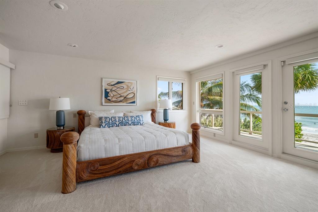16000 Gulf Boulevard Redington Beach, FL 33708 - Photo 28 of 47 a bed sitting in a spacious bedroom next to a large window