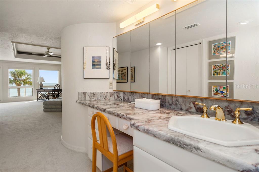 16000 Gulf Boulevard Redington Beach, FL 33708 - Photo 32 of 47 a bathroom with a granite countertop sink a mirror and a