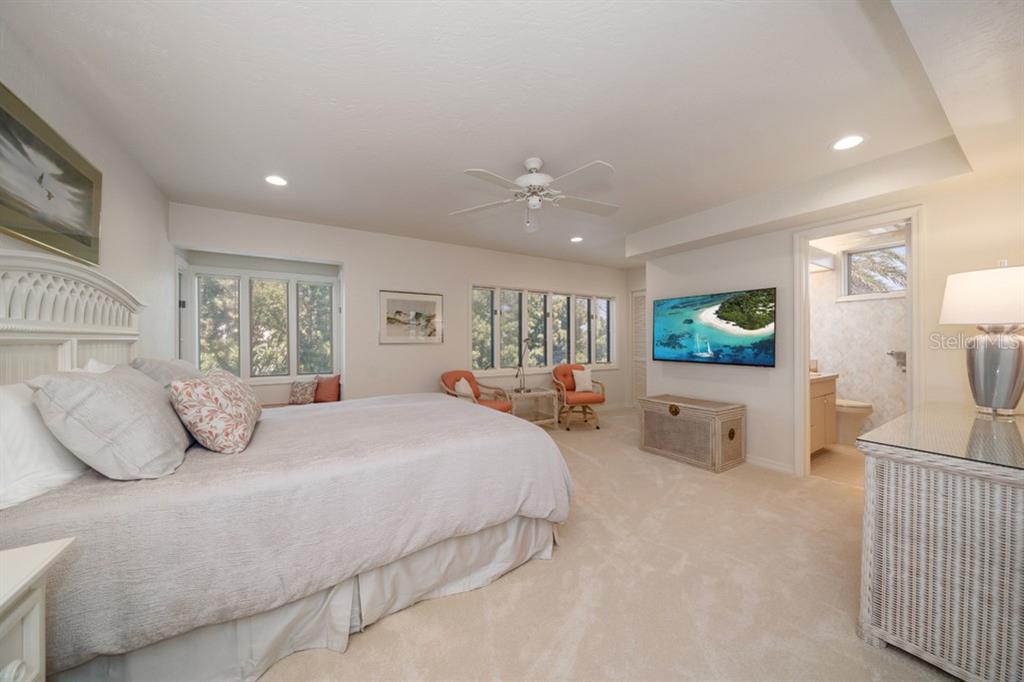 16000 Gulf Boulevard Redington Beach, FL 33708 - Photo 35 of 47 a bedroom with a large bed and a chandelier