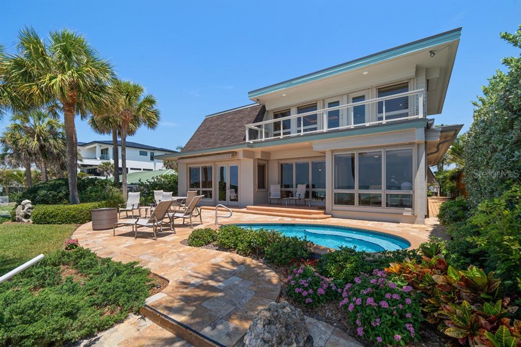 16000 Gulf Boulevard Redington Beach, FL 33708 - Photo 37 of 47 a front view of a house with swimming pool and garden