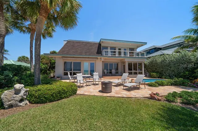a view of a house with backyard sitting area and garden