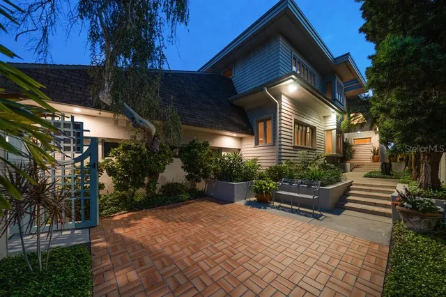 a view of a house with backyard and sitting area