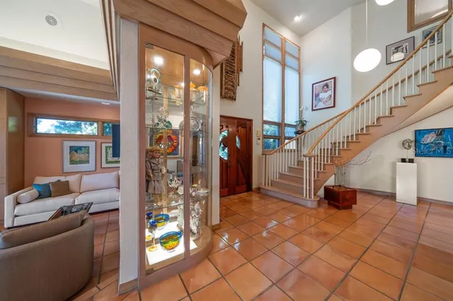 a living room with furniture and stairs