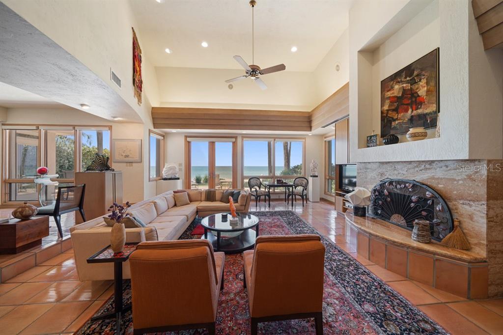 16000 Gulf Boulevard Redington Beach, FL 33708 - Photo 9 of 47 a living room with fireplace furniture and a large window
