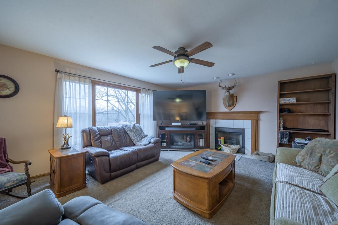 1982 Southgate Drive Lake Summerset, IL 61019 - Photo 13 of 33 a living room with furniture a ceiling fan a fireplace and a window
