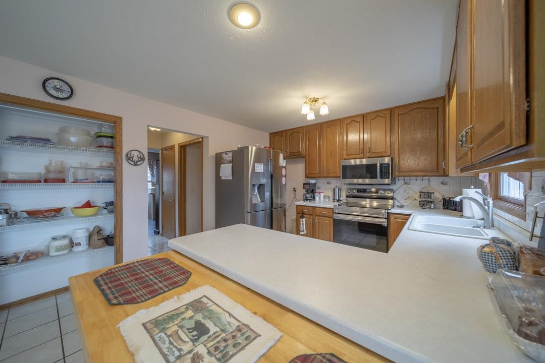 1982 Southgate Drive Lake Summerset, IL 61019 - Photo 15 of 33 a large kitchen with stainless steel appliances kitchen island granite countertop a refrigerator and a stove top oven
