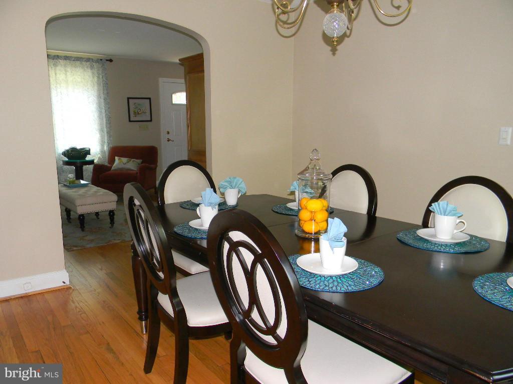 3923 Rexmere Road Baltimore, MD 21218 - Photo 6 of 21 a kitchen with a table chairs and a stove