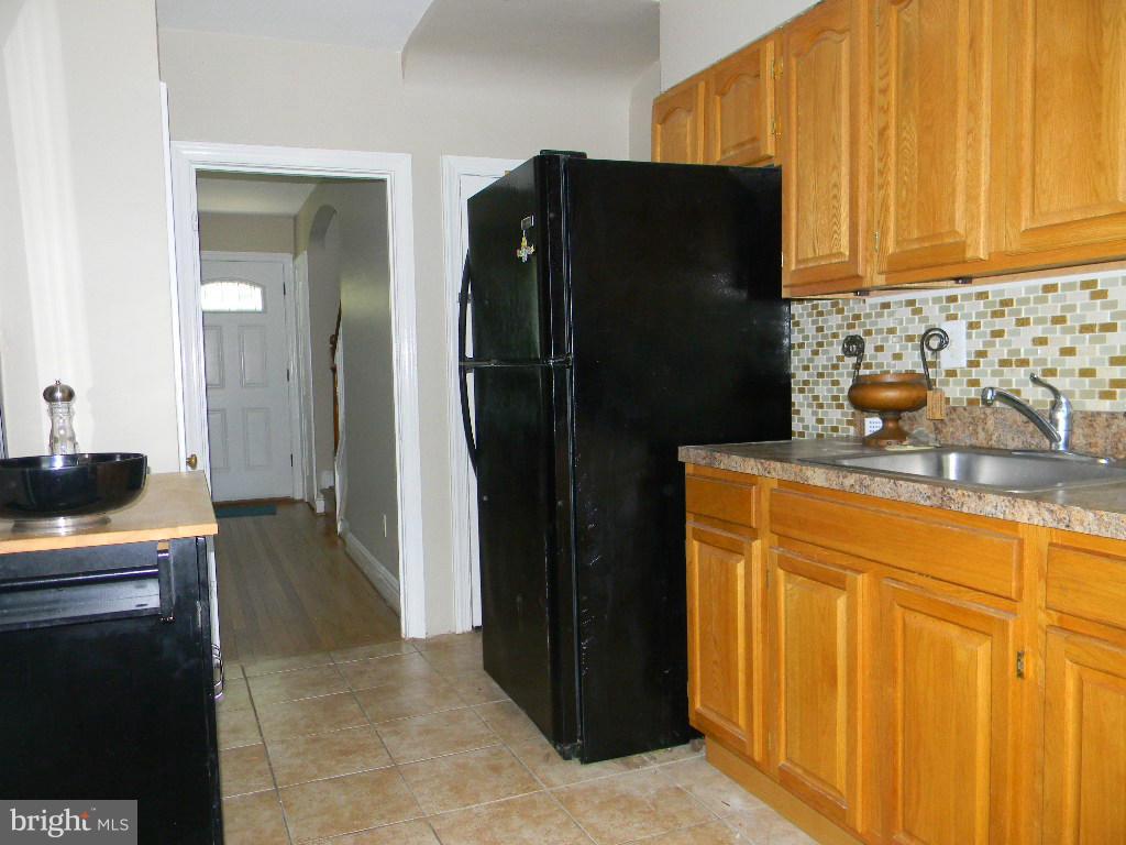 3923 Rexmere Road Baltimore, MD 21218 - Photo 7 of 21 a kitchen with stainless steel appliances granite countertop a refrigerator and a stove top oven