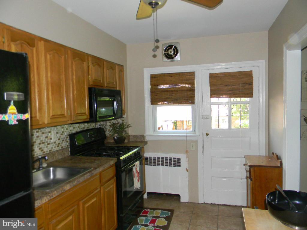 3923 Rexmere Road Baltimore, MD 21218 - Photo 9 of 21 a kitchen with a sink stove and microwave
