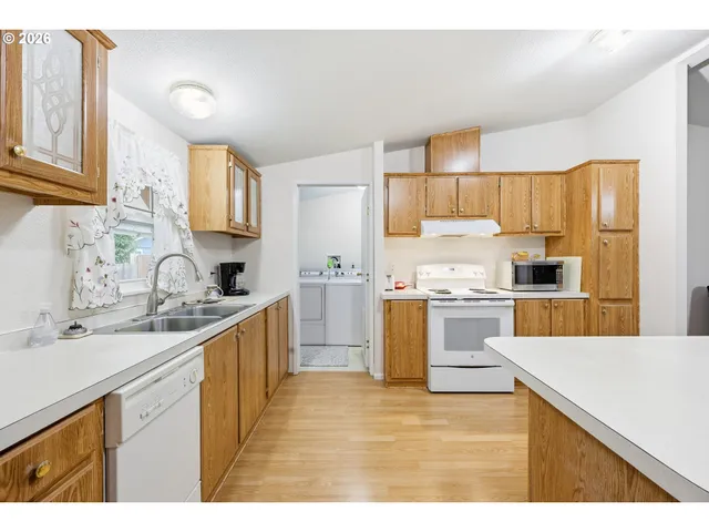 a kitchen with a sink stove top oven and refrigerator