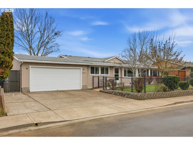 a view of a house with a yard and garage