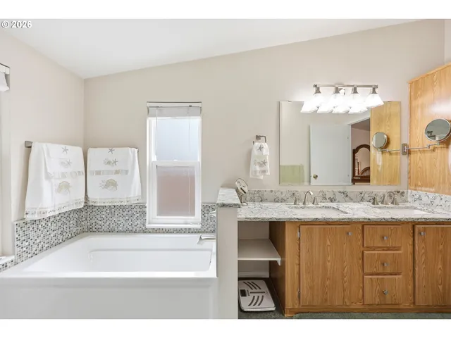 a bathroom with a bathtub sink and a mirror