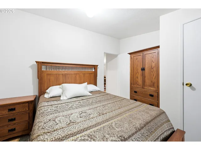 a bedroom with a bed and a dresser