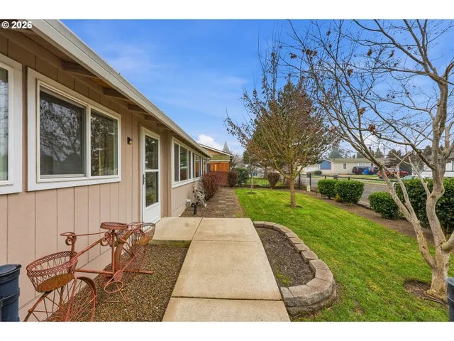 a view of a backyard with table and chairs and potted plants