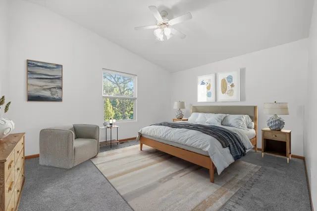 a spacious bedroom with a bed and furniture