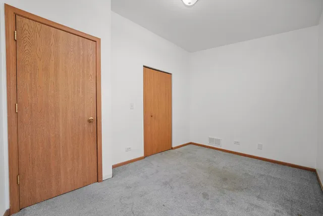 an empty room with closet area