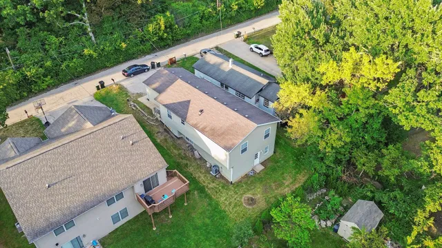 an aerial view of a house with garden space and street view