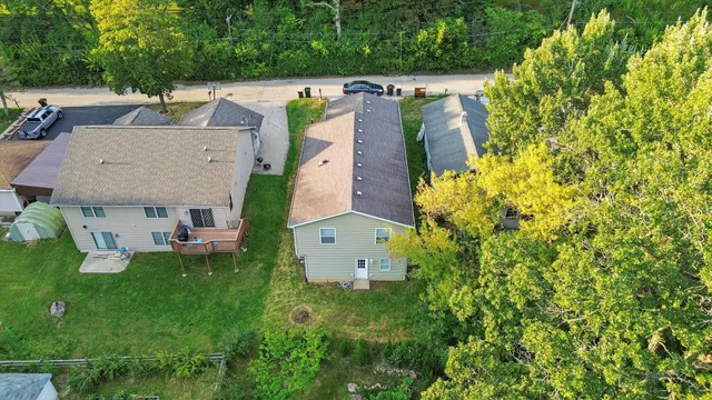 an aerial view of multiple houses with yard