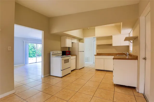 a kitchen with a stove top oven and cabinets