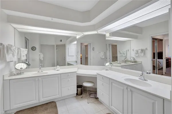a spacious bathroom with a double vanity sink and a mirror