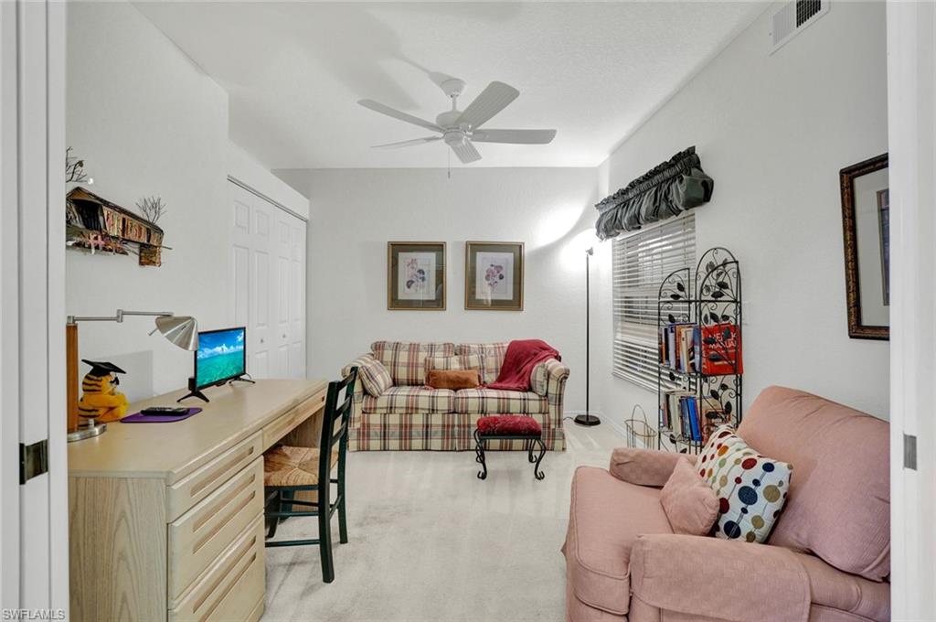 6883 Redbay Park Road, Unit 102 Naples, FL 34109 - Photo 15 of 22 a living room with furniture and wooden floor