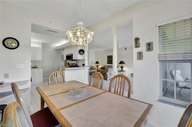 a view of a dining room with furniture and chandelier