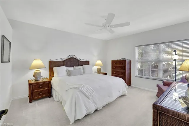 a bedroom with bed and a large window