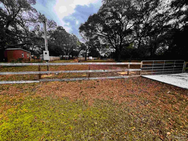a view of yard with wooden fence