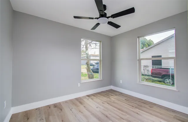 wooden floor in an empty room with a window