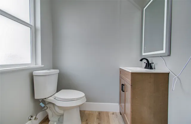 a bathroom with a toilet sink and mirror