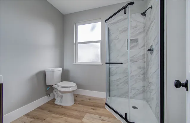 a bathroom with a toilet and a shower