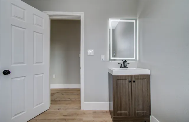 a bathroom with a sink and a mirror