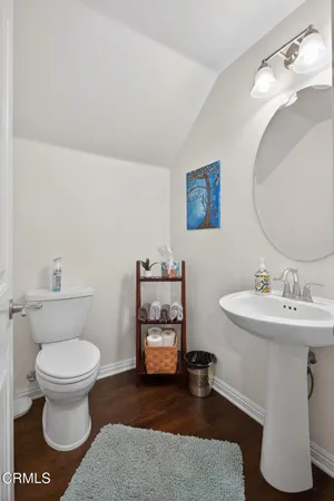 a bathroom with a toilet and a mirror
