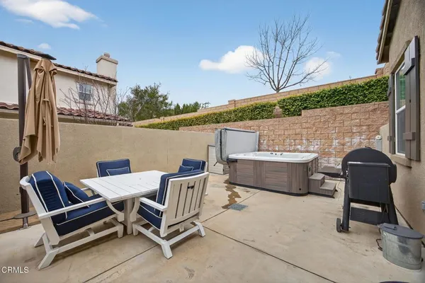a couple of chairs sitting in patio of a house