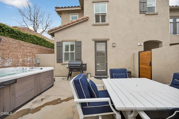a view of a patio with dining table and chairs