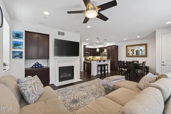 a living room with furniture a fireplace and a flat screen tv