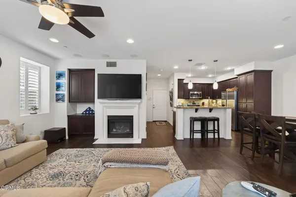 a living room with furniture a fireplace and a flat screen tv