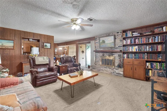 a living room with furniture and a book shelf