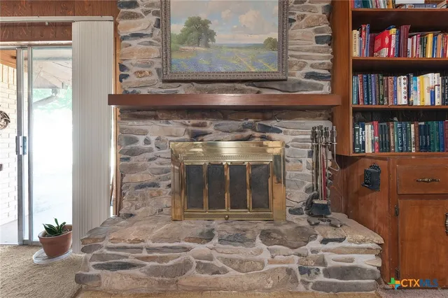 a living room with hard wood floors and a fireplace