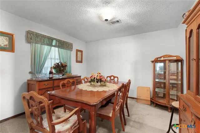 a dining room with furniture and window