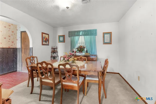 a dining room with furniture and window