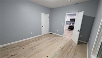 60 Dunham Street, Unit 1 Attleboro, MA 02703 - Photo 5 of 9 a view of a room with wooden floor and a bathroom