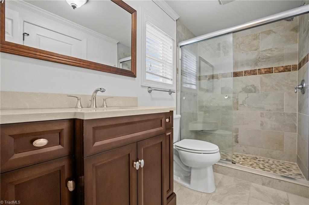 8440 West Harrell Road Oak Ridge, NC 27310 - Photo 12 of 50 Tile shower, primary bathroom